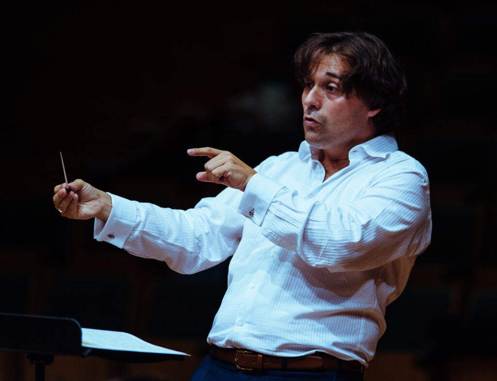 Pablo Conducting an Orchestra in a White Shirt
