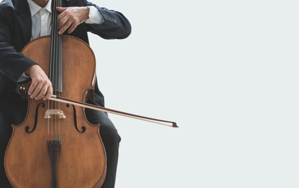 A Man Playing a Cello on a White Background