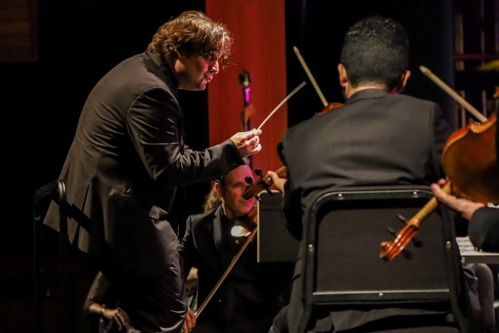 An orchestrator performing on the stage