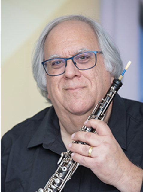 A Man With Grey Hair Holding a Saxophone